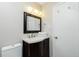 Cozy bathroom featuring a dark vanity and convenient towel rack at 31037 Prairie Creek Dr, Punta Gorda, FL 33982