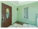 Inviting entryway with a wood door, light green walls, and tiled floor at 31037 Prairie Creek Dr, Punta Gorda, FL 33982