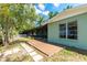 Backyard facade with a wood deck, screened-in lanai, yard and single-pane windows at 31037 Prairie Creek Dr, Punta Gorda, FL 33982