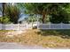 Charming home with a white picket fence and mature trees providing shade and privacy at 31037 Prairie Creek Dr, Punta Gorda, FL 33982