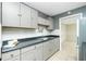 Well-lit kitchen with gray cabinets, sleek countertops, and white subway tile backsplash for a modern touch at 31037 Prairie Creek Dr, Punta Gorda, FL 33982