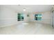 Spacious living area with tile floors, large windows, and serene water views at 31037 Prairie Creek Dr, Punta Gorda, FL 33982