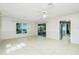 Bright living space with tile floors, sliding doors, and seamless kitchen access at 31037 Prairie Creek Dr, Punta Gorda, FL 33982