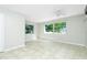 Bright living room with tile floors, ceiling fan, and plenty of natural light at 31037 Prairie Creek Dr, Punta Gorda, FL 33982