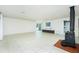 Bright living room featuring a fireplace, tiled flooring, and seamless indoor-outdoor flow at 31037 Prairie Creek Dr, Punta Gorda, FL 33982