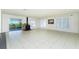 Spacious living room boasts tiled floors, a fireplace, and sliding glass doors leading to the outdoors at 31037 Prairie Creek Dr, Punta Gorda, FL 33982