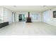 Bright living room with tile floors, fireplace, and sliding glass doors offering natural light at 31037 Prairie Creek Dr, Punta Gorda, FL 33982