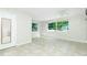 Bright living room with tile floors, ceiling fan, and plenty of natural light at 31037 Prairie Creek Dr, Punta Gorda, FL 33982