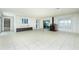 Open-concept living room with tile flooring, built-in shelving, and a cozy fireplace at 31037 Prairie Creek Dr, Punta Gorda, FL 33982