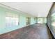Spacious screened lanai with brick flooring and several access doors into the home at 31037 Prairie Creek Dr, Punta Gorda, FL 33982