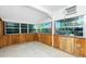 Bright sunroom featuring wood paneling and lots of windows with lots of natural light at 31037 Prairie Creek Dr, Punta Gorda, FL 33982