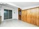 A view of the sunroom featuring a sliding door, wood paneling, and tile flooring at 31037 Prairie Creek Dr, Punta Gorda, FL 33982