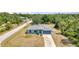 A single Gathering home in a tranquil neighborhood, featuring a long driveway and beautifully maintained lawn at 3104 Garbett Ter, North Port, FL 34288