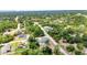 A tranquil neighborhood is seen with verdant trees surrounding single-Gathering homes, with clear roads for accessibility at 3104 Garbett Ter, North Port, FL 34288
