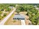 The property is set in a serene, tree-lined area with a fenced-in backyard and a long driveway at 3104 Garbett Ter, North Port, FL 34288