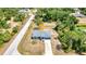 Aerial view of the house with a well maintained lawn, complemented by the surrounding lush trees at 3104 Garbett Ter, North Port, FL 34288