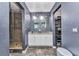 Modern bathroom with double vanity, white cabinets, granite counters, and stylish tiled shower at 3104 Garbett Ter, North Port, FL 34288
