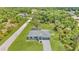 Aerial view of the property showcasing a well-maintained lawn, fenced pool and landscaping at 3104 Garbett Ter, North Port, FL 34288