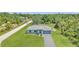 Charming single-story home featuring a well-manicured lawn and a lovely modern blue gray color scheme at 3104 Garbett Ter, North Port, FL 34288