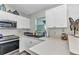 Bright kitchen featuring white cabinetry, stainless steel appliances, and ample counter space at 3104 Garbett Ter, North Port, FL 34288