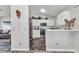 Modern kitchen with stainless steel appliances, white cabinets, and stylish gray tiled floors at 3104 Garbett Ter, North Port, FL 34288