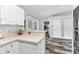 Spacious kitchen with white cabinets, bar seating, and modern flooring, creating an inviting cooking space at 3104 Garbett Ter, North Port, FL 34288