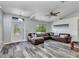 Inviting living room featuring wood floors, and a comfortable brown leather sectional sofa at 3104 Garbett Ter, North Port, FL 34288
