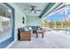 Inviting covered patio with wicker seating, ceiling fan, and view of the pool at 3104 Garbett Ter, North Port, FL 34288