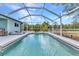 Inviting screened-in pool surrounded by lush landscaping and a peaceful atmosphere at 3104 Garbett Ter, North Port, FL 34288