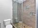 Attractive updated shower with tiled walls, pebble floor and glass enclosure at 3104 Garbett Ter, North Port, FL 34288