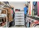 Spacious walk-in closet with shelves, hanging racks, a dresser and a safe for valuables at 3104 Garbett Ter, North Port, FL 34288