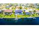 Aerial view of modern waterfront home with pool, dock, and lush landscaping, perfect for relaxing at 3520 Caya Largo Ct, Punta Gorda, FL 33950