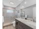 Modern bathroom with a dual sink marble vanity, a frameless glass shower, and neutral decor at 3520 Caya Largo Ct, Punta Gorda, FL 33950