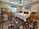 Cozy bedroom with an area rug, a queen-sized bed, nightstands, and a chest of drawers at 3520 Caya Largo Ct, Punta Gorda, FL 33950