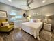 Cozy bedroom with tiled floors, ceiling fan, and neutral wall color at 3520 Caya Largo Ct, Punta Gorda, FL 33950
