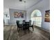 Dining room with large windows, modern chandelier, and seating for six at 3520 Caya Largo Ct, Punta Gorda, FL 33950
