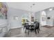 Dining area with a glass table and seating for six, complemented by an elegant chandelier at 3520 Caya Largo Ct, Punta Gorda, FL 33950