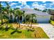 Charming home with a lush lawn, freshly landscaped garden beds, and a brick paved driveway with plenty of parking at 3520 Caya Largo Ct, Punta Gorda, FL 33950