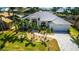 Stunning single-story home featuring a new metal roof, beautiful landscaping, and a paver driveway at 3520 Caya Largo Ct, Punta Gorda, FL 33950