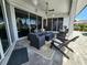 Covered outdoor patio with sliding glass doors, seating, and a view of the water at 3520 Caya Largo Ct, Punta Gorda, FL 33950