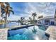 Sparkling pool overlooking the waterfront canal, surrounded by lush landscaping and lounge chairs at 3520 Caya Largo Ct, Punta Gorda, FL 33950