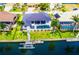 Aerial view of waterfront home with a pool, boat dock, and a metal roof at 3520 Caya Largo Ct, Punta Gorda, FL 33950