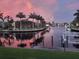 Canal waterfront view showcasing luxury homes, boats, and tranquil waters reflecting a colorful sunset at 3520 Caya Largo Ct, Punta Gorda, FL 33950