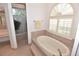 Bright bathroom featuring a soaking tub, a walk-in shower with garden view, and vanity area at 3787 Whippoorwill Ct, Punta Gorda, FL 33950