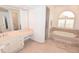 Elegant bathroom with a soaking tub, vanity, and a separate glass-enclosed shower at 3787 Whippoorwill Ct, Punta Gorda, FL 33950