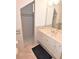 Bathroom featuring a marble tile floor, a walk-in shower, and vanity with mirror at 3787 Whippoorwill Ct, Punta Gorda, FL 33950