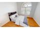 A bright bedroom features wood floors, a large window, and a stylish headboard with built-in shelving at 3787 Whippoorwill Ct, Punta Gorda, FL 33950