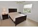 Bright bedroom features neutral carpet, ceiling fan, and natural light from the window at 3787 Whippoorwill Ct, Punta Gorda, FL 33950