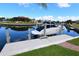 Scenic view of a boat docked on the canal, complemented by waterfront homes at 3787 Whippoorwill Ct, Punta Gorda, FL 33950