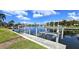 Waterfront view showcasing the boat dock and lift against a backdrop of waterfront homes at 3787 Whippoorwill Ct, Punta Gorda, FL 33950